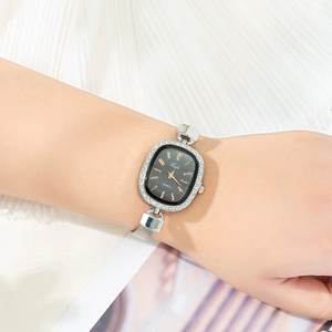 Women's quartz watch with black oval dial, rhinestone bezel and silver mesh strap