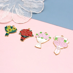 Detailed view of four colorful enamel flower bouquet pendants with golden metal loops