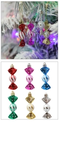 Detail showing various colorful candy-shaped Christmas tree ornaments in different finishes