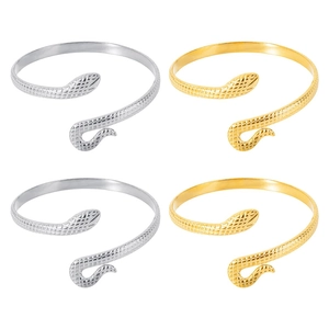 Detailed view of snake-shaped C-cuff bracelets in gold and silver with scale textures