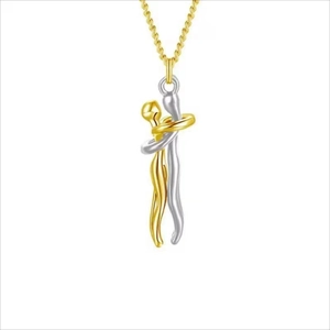 Detail view of stylized gold and silver hug pendant necklaces on white background