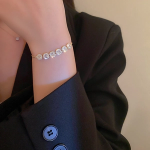 Close-up of sparkling silver rhinestone bracelet on model wrist with adjustable chain