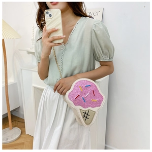 Close-up of pink sequined ice cream shaped crossbody bag with golden chain strap detail