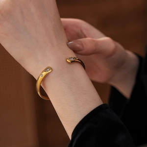 Detailed view of adjustable gold-plated stainless steel cuff with waterdrop zircons