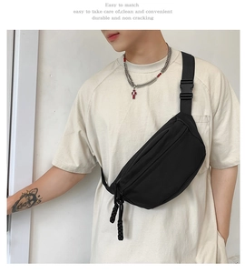 Detail view of durable black canvas crossbody bag with dual corded zippers and adjustable strap