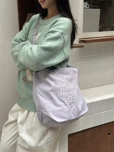 Minimalist light purple canvas tote bag with white embroidery and adjustable shoulder strap