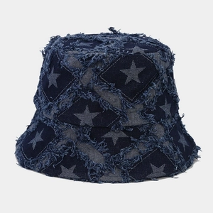 Detail of distressed blue denim bucket hat featuring raw edges and star patchwork pattern