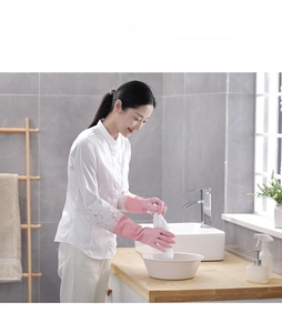 Detail of pink waterproof household gloves with floral printed extended sleeves