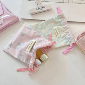 Flat lay of cute cat pattern drawstring storage bags for cosmetics and small travel items
