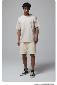 Detail of light grey oversized cotton t-shirt with crew neck and matching drawstring shorts