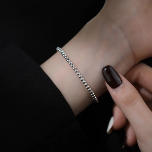 Minimalist S925 sterling silver bead bracelet with adjustable slide clasp on a model wrist
