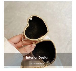 Detail view of heart-shaped mini evening bag with magnetic closure and golden metal frame