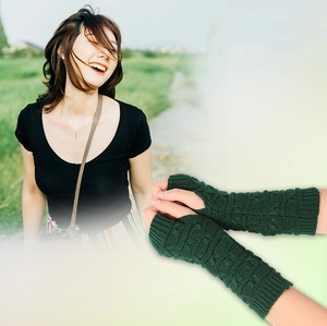 Detail of dark green cable knit long fingerless gloves with soft textured wrist warmers