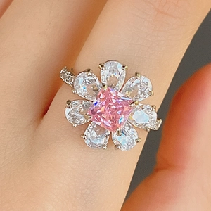 Elegant flower ring with pink princess cut zircon and teardrop petals in silver setting