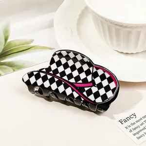 Detail shot of acrylic large hair claw clip with checkered pattern and pink accent lines