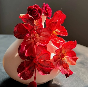Exquisite red rose drop earrings with velvet petals and silk tassels on ceramic vase