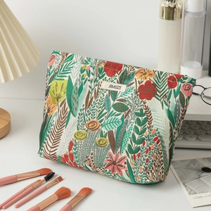 Close-up of a floral embroidery cosmetic bag with jacquard fabric and a brand label