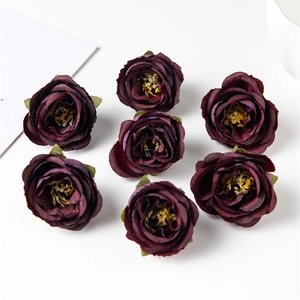 Detail of seven deep purple silk faux rose heads for DIY crafts and wedding decor