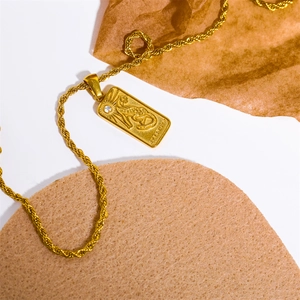 Detail of 18K gold plated rope chain and tarot pendant with strength lion engraving