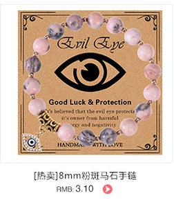 Macro view of 8mm pink zebra stone beads and crystal-encrusted Evil Eye charm on bracelet