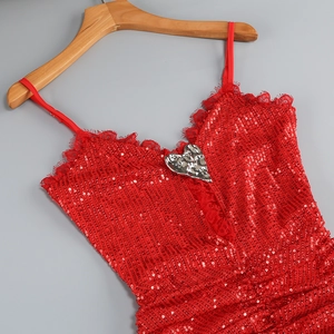 Detail of red sequin dress featuring silver heart metal buckle and lace trim details