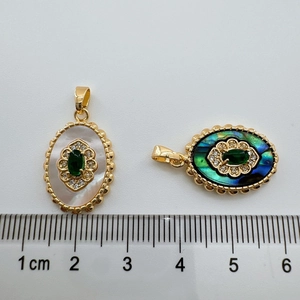 Detailed size measurement of 18K gold plated emerald shell charms with a ruler display