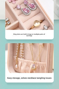 Macro detail of pink jewelry box with 6 ring slots and tangle-free necklace hooks