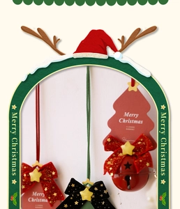 Close-up of red Christmas bell with velvet bow and star accessory on tree card