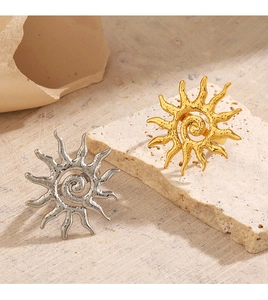 Detailed view of 18K gold and silver sun rings with textured finish on stone