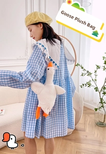 Cute white goose plush bag shown in a lifestyle scene with adjustable strap details