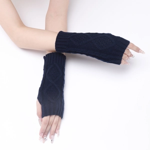 Detail of diamond cable knit pattern on navy blue fingerless gloves for women