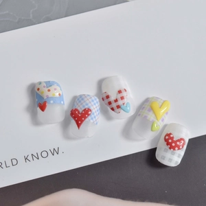 Detail of matte jelly nail stickers featuring 3D resin hearts and colorful plaid patterns