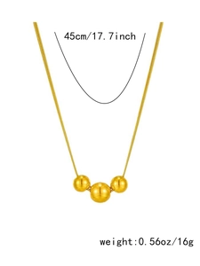 Detail of gold titanium steel necklace featuring three polished spherical beads on snake chain
