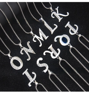 Macro detail of silver stainless steel necklaces with sparkling rhinestone capital letters