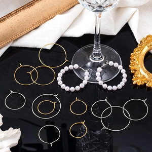 Macro shot of assorted gold and silver DIY hoop earrings with elegant pearl details