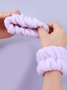 Elastic light purple plush wristbands and headband set shown stretched for face washing
