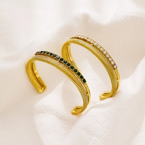Double-layered gold fishbone bangle with green gemstone and white rhinestone inlay