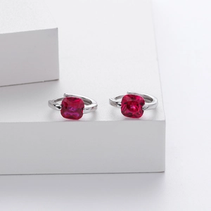 Macro view of S925 sterling silver hoop earrings with square red zircon gemstones