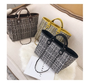 Three tweed tote bags in brown, yellow and plaid colors with chain details on a sofa