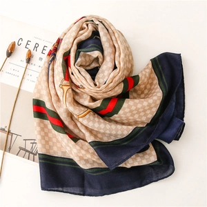 Detail showing vintage horsebit pattern and red-green stripes on linen-feel scarf