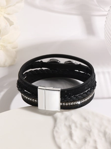 Macro shot of black multi-layer leather bracelet with rhinestone and silver magnetic clasp