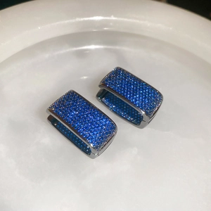 Detail of blue cubic zirconia pavé setting on rectangular double-layer U-shaped earrings