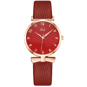 Women's quartz watch with red leather strap and rose gold case on white background