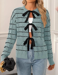 Detail view of the Morandi blue knitted cardigan featuring three black bow tie closures