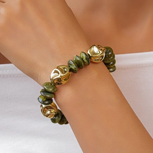 Detail of green marble beads and spiral gold metal beads on a vintage style bracelet