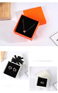 Elegant orange jewelry gift boxes featuring a luxury necklace, heart earrings, and a silver ring
