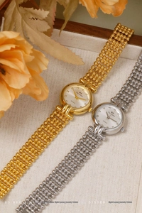Detail of luxury gold and silver ladies watches with crystal markers and beaded bands