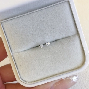 Close-up of S925 silver heart stud earrings with 5A zircon in a white velvet gift box