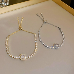 Detail of adjustable zircon tennis bracelets in gold and silver finish with crystal shine