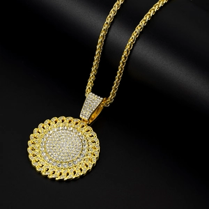 Detailed shot of gold-plated twisted chain with round iced-out rhinestone pendant
